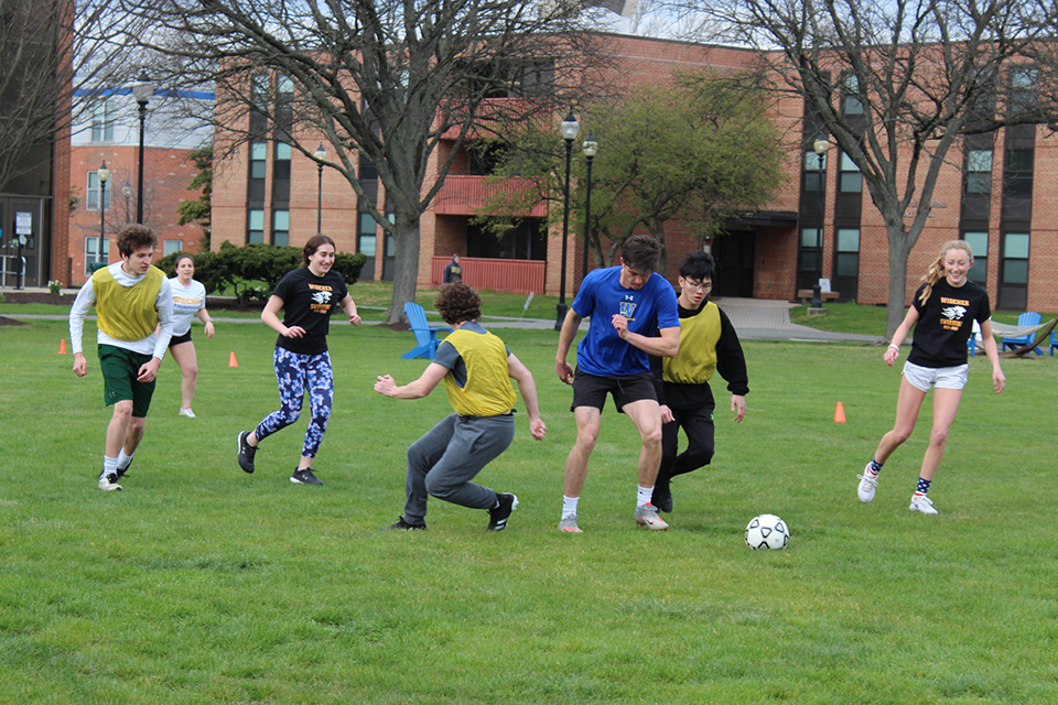 Group of students playing soccer on Memorial Field