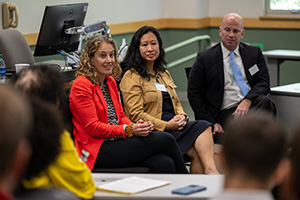Panelists speaking to attendees