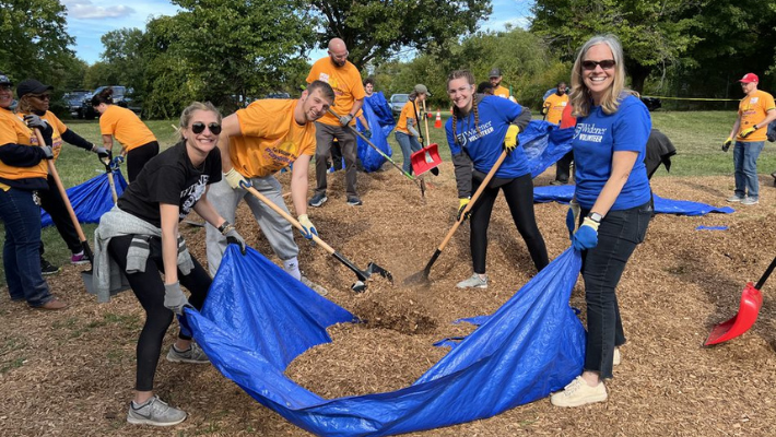 Widener University President Stacey Robertson joins students for a community service project at Kaboom playground in Chester.
