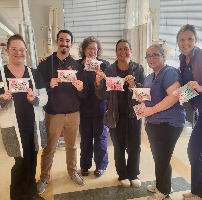 Widener Dining, nursing students, and nurses pose with support bags for breast cancer patients.