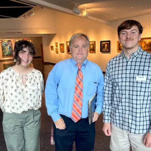 Cloe DiFlumeri poses alongside two individuals during an internship at Museum of Arts and Sciences.