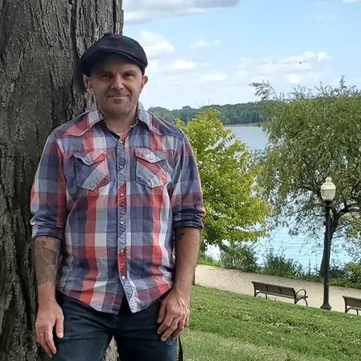 Randy LeBar leaning against a tree