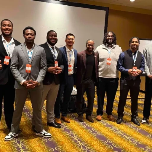 Justin Mack and other conference attendees pose for a photo