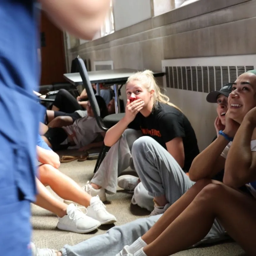 A female student acts injured during the simulation