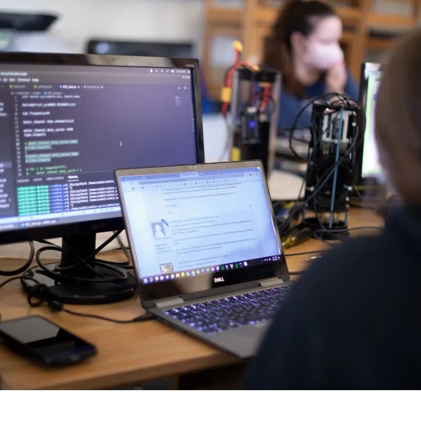 Students work on computer to program code for a project