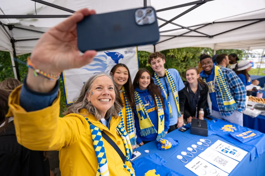 President Robertson takes a selfie with students