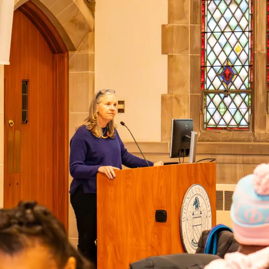 President Stacey Robertson speaks at podium.