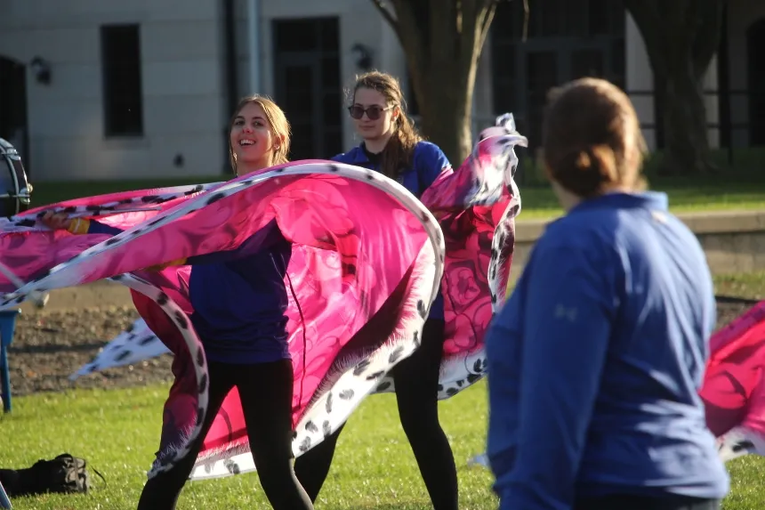 Color guard waving pink flags