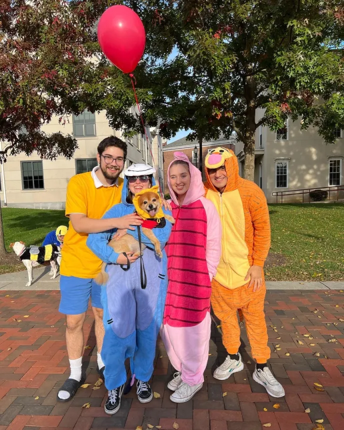 Four people dressed up like Winnie the Pooh characters at the Strut Your Mutt event