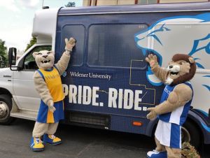 Widener Mascots post with Widener Bus that reads PRIDE. RIDE. with lion graphic
