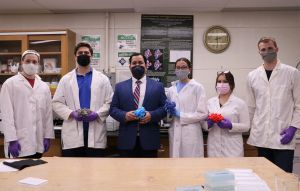 Professor Patil poses in the lab with five members of his student-research team.