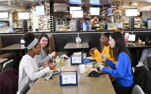Four Widener students eating lunch in the Pride Cafe