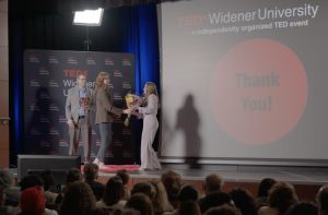 Amanda accepts flowers on stage at TEDx.