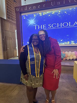 Taylor Easter and Marina Barnett pose for a photo at an award's ceremony