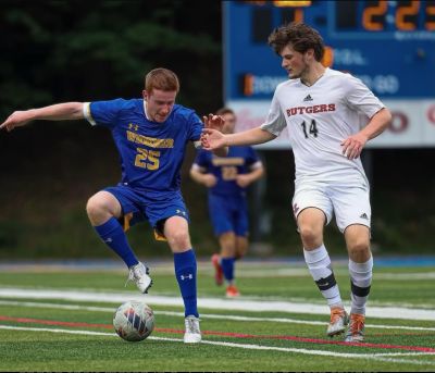 Bruce McGarvey, in blue Widener uniform, playing soccer
