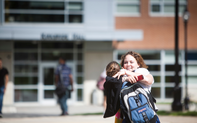 Students hug outside Kapelski Learning Center on Widener University' campus.
