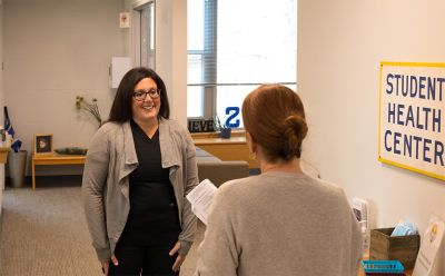 MSN student Lauren talks with a colleague at work.