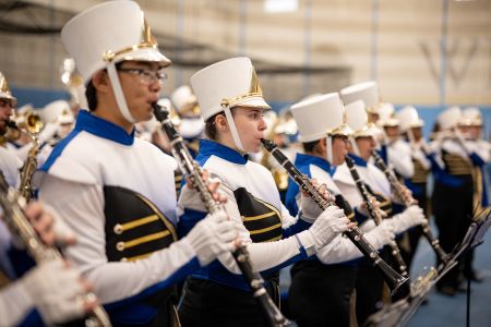 Group of marching band members playing their clarinets