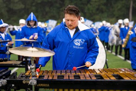 Marching Band member playing the xylophone on the field