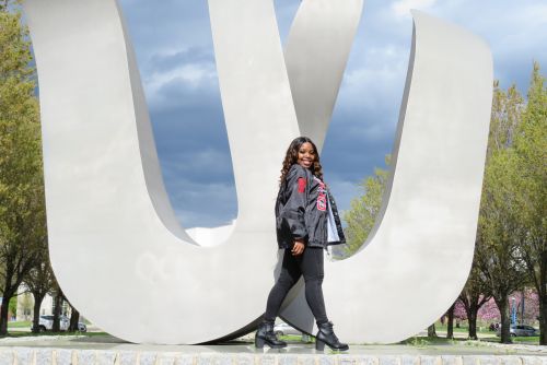 Student Trustee Ijjae Hill 960x640 Student Ijjae Hill stands in front of the 'W' statue