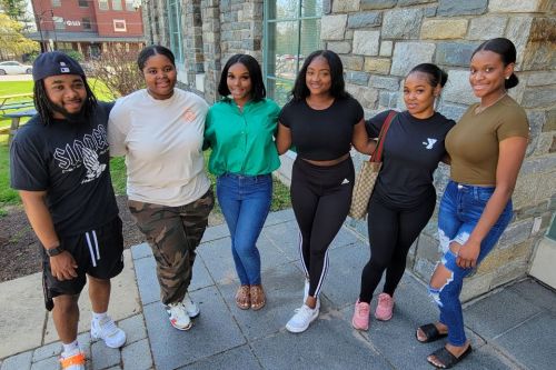 Six Widener students who are WPCS alumni standing arm-in-arm