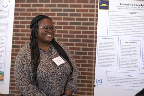 Taylor Easter SURCA Taylor Easter next to her SURCA poster