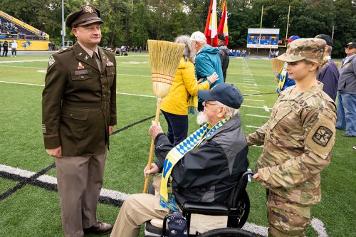 R-O-T-C cadet with her P-M-C alum grandfather during the Homecoming broom drill