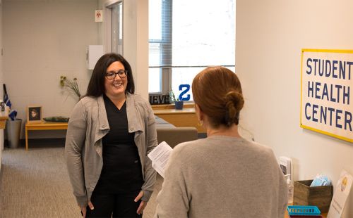 MSN student Lauren talks with a colleague at work.