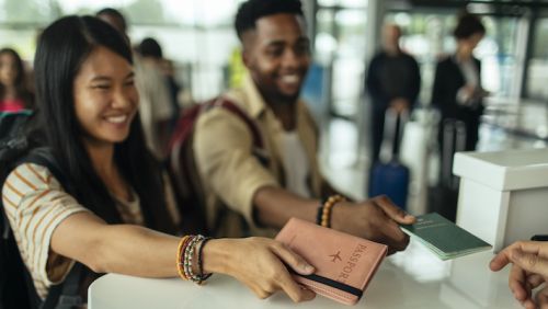 students at airport with passports