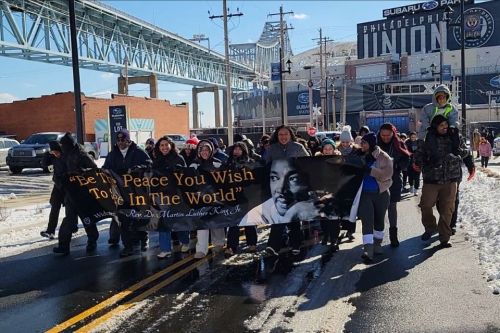 MLK peace march 2025 960 x 640 Widener students, community members, and university partners hold a sign and lead the MLK Day of Service peace march outside of the Philadelphia Union stadium.