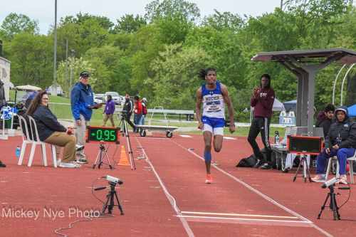 Matayo McGraw, wearing a Widener track shirt, runs on a track as he prepares to jump