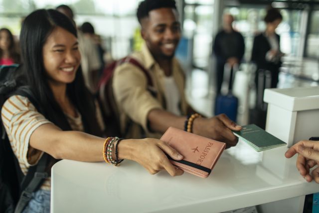 students at airport with passports